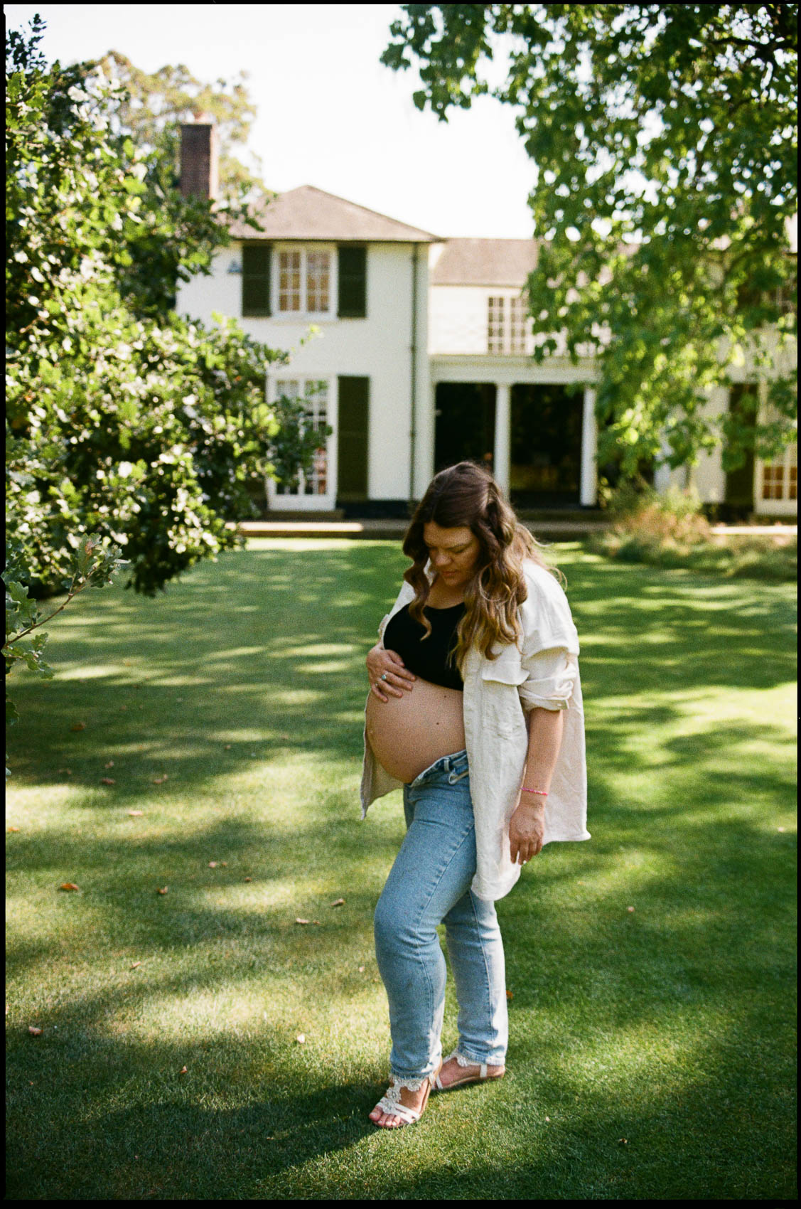 pregnant mum stands in the cambridge university botanical garden for her maternity photos